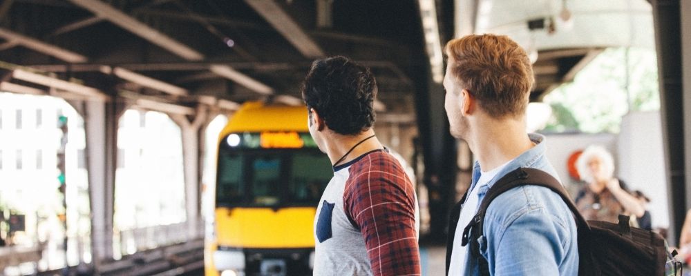 Two men waiting at train station